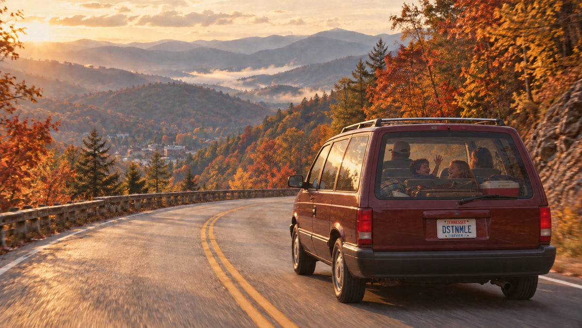 A 1990s family minivan winding through the Smoky Mountains toward Gatlinburg, kids playing in the second row and luggage packed in the back