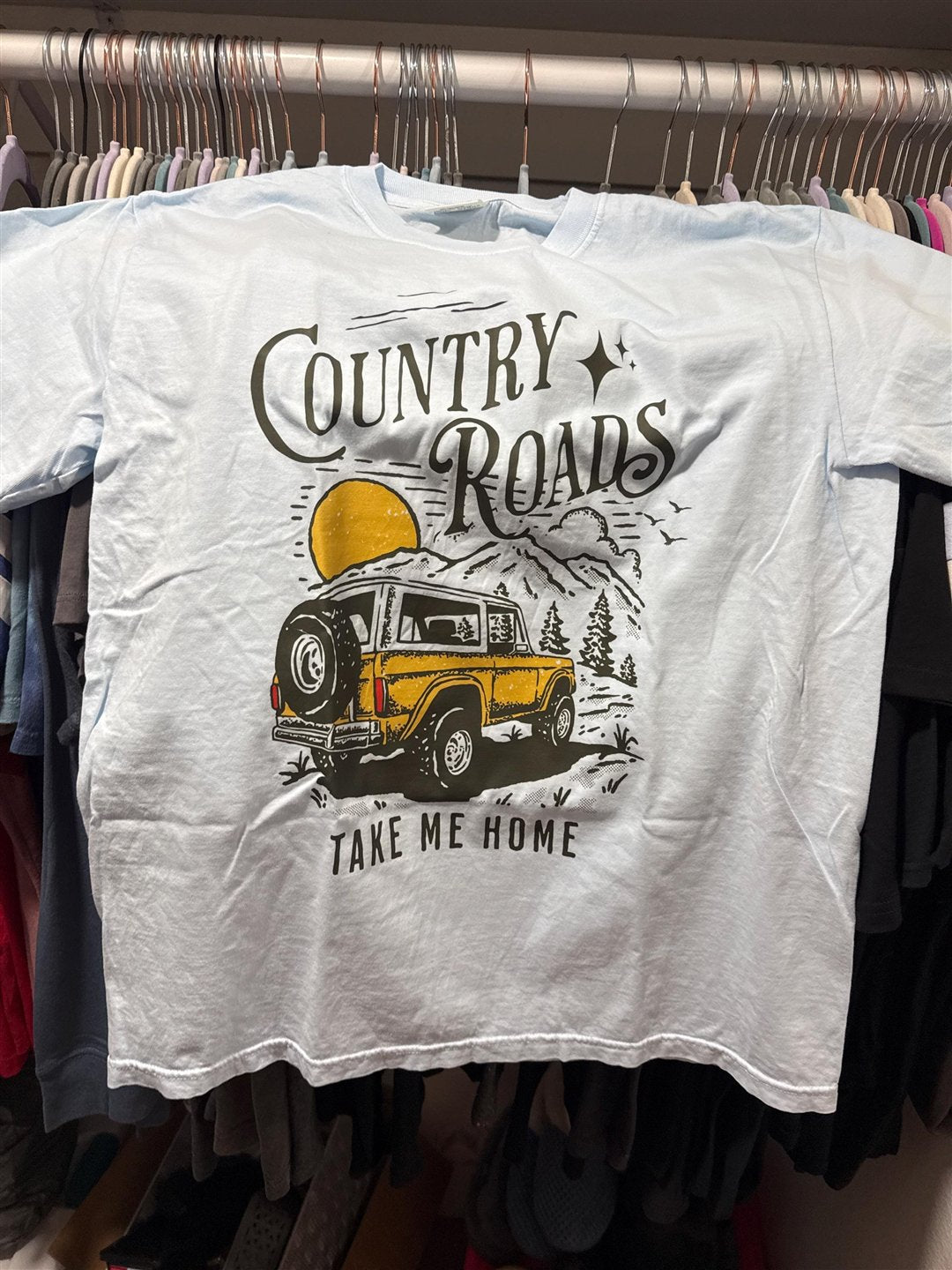 Country Roads tee on a hanger, photo from a customer